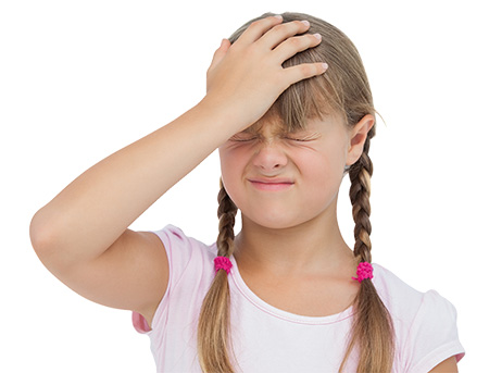 Little girl suffering from headache and touching her head on white background